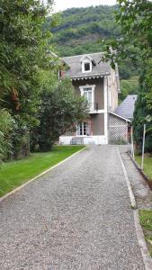 a house with a driveway in front of it at Gîte Illixo in Luchon