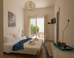 a bedroom with a bed and a table and a window at Coru e Mari - City Center & Private Parking in Pula