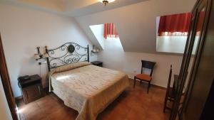 a bedroom with a bed and a chair in it at Coso Viejo in Antequera
