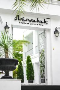 a sign for a boutique culture villa with a fountain at Noursabah Pattaya in Pattaya Central