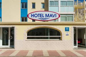 
a building with a sign on the front of it at Hotel Mavi in Gandía
