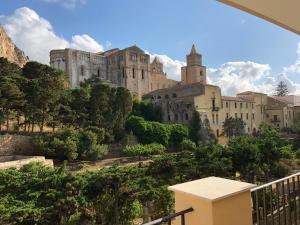 a castle on top of a hill with trees at La Casa Sulla Scogliera in Cefalù