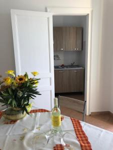 a bottle of wine on a table in a kitchen at La Casa Sulla Scogliera in Cefalù