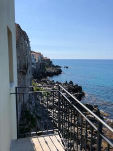 a view of the ocean from a balcony of a building at La Casa Sulla Scogliera in Cefalù