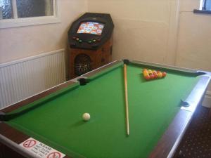 a pool table with a cue ball and a video game at Wellington Hotel in Blackpool
