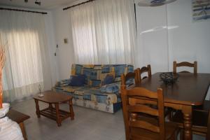 a living room with a couch and a table at Apartamentos Porta Mediterranea in Alcossebre