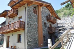 a house with wooden balconies on the side of it at Casa Alpina - Sarre in Aosta