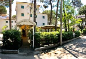 a building with a sign in front of a street at Hotel Fiorenza in Milano Marittima