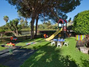 a playground with a slide in the grass at BlueBay Banús in Marbella