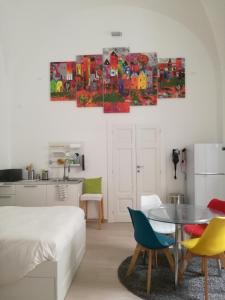 a bedroom with a bed and a table and chairs at HOUSE of COLORS in Bari