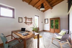a living room with a wooden table and chairs at Agriturismo Braciami in Viterbo