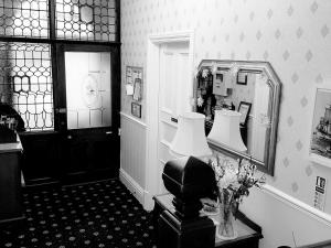 a room with a mirror and a table with a lamp at Crescent Lodge Guest House in Whitby +7 photos