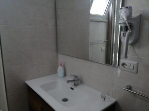 a bathroom with a sink and a mirror at Hotel Tirreno Formia in Formia