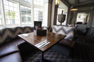 a living room with a couch and a wooden table at The White Hart in Whitchurch