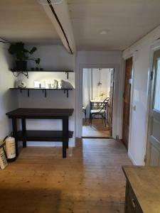 a living room with a table and a dining room at 4B Österlen Bed & Breakfast in Tomelilla +41 photos