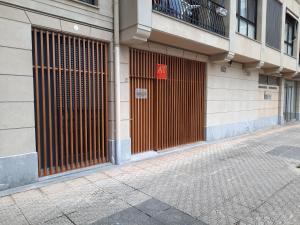 a building with a brown gate on the side of it at Loft en Zarautz con Parking Hator 2 in Zarautz