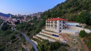a building on the side of a hill next to a river at ΜΠΑΡΟΥΤΟΜΥΛΟΣ -Baroutomilos in Dimitsana