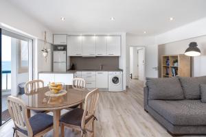 a kitchen and living room with a table and a couch at Heritage Caeli in Portimão