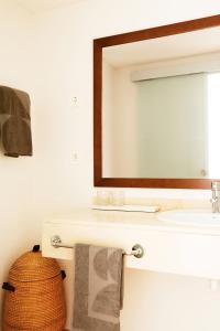 a bathroom with a sink and a mirror at Sunprime Atlantic View Suite & Spa in Playa del Ingles