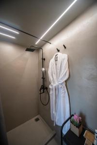 een badkamer met een badjas aan een muur bij Urban Sea View Lofts #2 in Chalkida