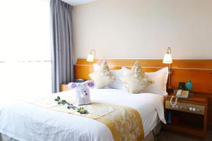 Voodi või voodid majutusasutuse Yihe Hotel Ouzhuang toas