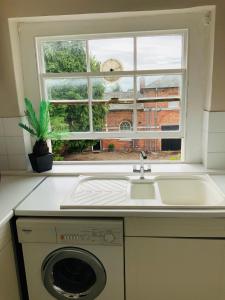 a kitchen with a sink and a window at The Stables Apartment in Newark-on-Trent +9 photos