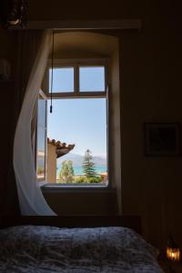 a bedroom with a large window with a view at Mora Valisi in Nafplio