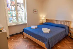 a bedroom with a blue bed with two towels on it at PORTOVECCHIO in Levanto