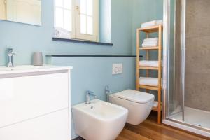 a bathroom with a toilet and a sink and a mirror at PORTOVECCHIO in Levanto