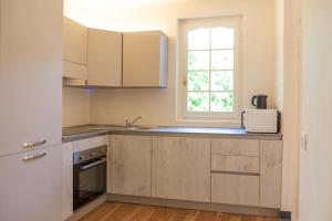 a kitchen with white cabinets and a window at PORTOVECCHIO in Levanto