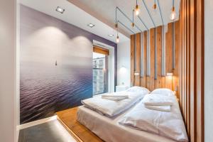 a bedroom with two beds and a view of the ocean at Apartamenty Sun & Snow Chmielna Park in Gdańsk
