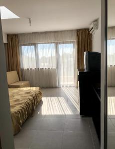 a hotel room with a bed and a television at Villa Anastasia in Costinesti