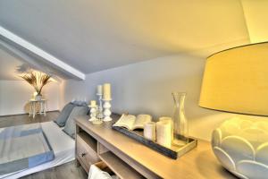 a bedroom with a bed and a table with a lamp at Dida moj in Senj +37 photos