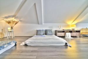 a large white bedroom with a bed and a desk at Dida moj in Senj