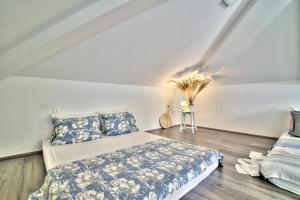 a bedroom with a bed and pillows on a wooden floor at Dida moj in Senj