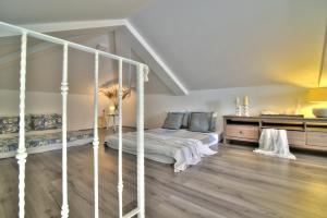 a bedroom with a canopy bed and wooden floors at Dida moj in Senj