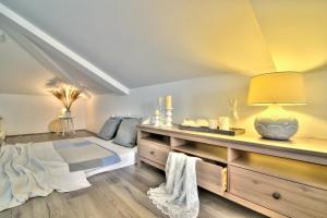 a bedroom with a bed and a table with a lamp at Dida moj in Senj