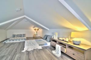 a attic room with a bed and a desk at Dida moj in Senj