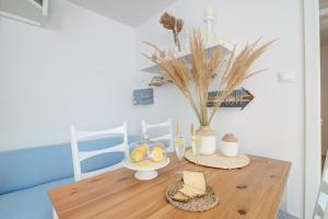 a wooden table with a plate of fruit on it at Dida moj in Senj