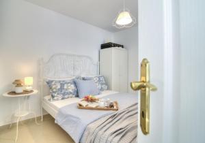a bedroom with a bed with a tray of food on it at Dida moj in Senj