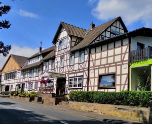 a large house on the side of a street at Hotel Fröhlich-Höche in Uslar