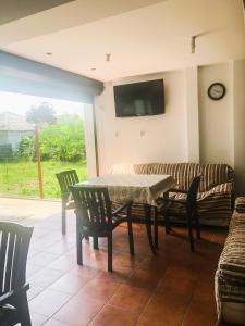 a living room with a table and a couch at Villa Anastasia in Costinesti