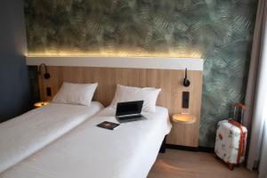 Ein Bett oder Betten in einem Zimmer der Unterkunft ibis Brussels Waterloo