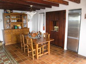 a kitchen with a wooden table and chairs at Casa Rural Casa & Monte in Casas del Monte +19 photos