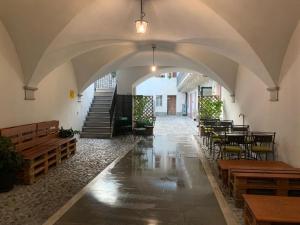 an empty room with tables and benches in a building at AFFITTACAMERE DA ANDRE E MARY in Venzone