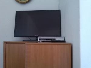 a flat screen tv sitting on top of a wooden cabinet at Rooms Katica in Korčula +33 photos