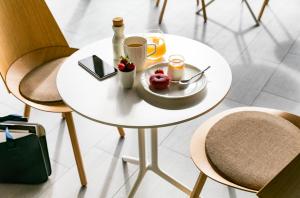 a white table topped with plates and bowls of food at Okko Hotels Lyon Pont Lafayette in Lyon