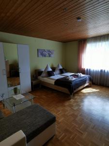 a bedroom with a bed in a room with a window at Hotel Mainperle in Wertheim