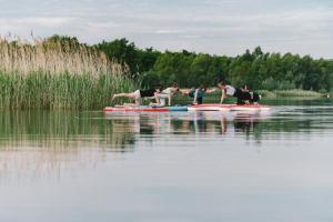 a group of people on a paddle board in the water at Insel der Sinne Naturhotel in Görlitz +93 photos