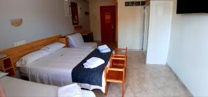 Postel nebo postele na pokoji v ubytování Hotel Alaska